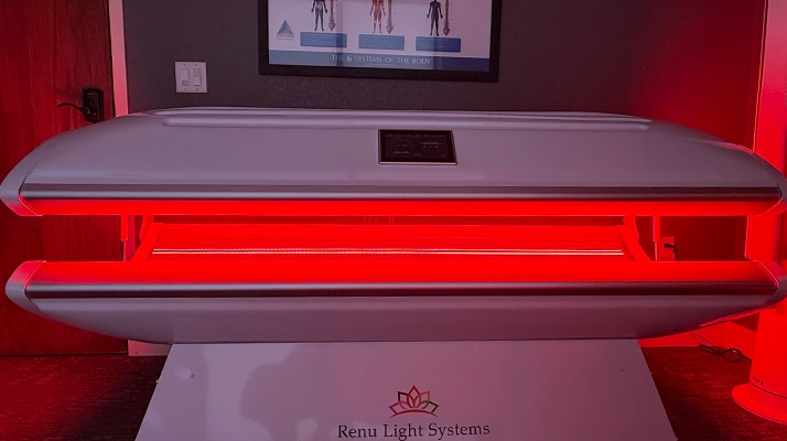 Renu Red Light Therapy bed featuring full-body red light treatment at Atlas Chiropractic & Acupuncture.